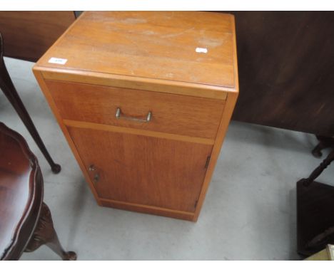 A vintage oak bedside cabinet