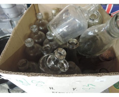 A box of vintage glass bottles and flagons