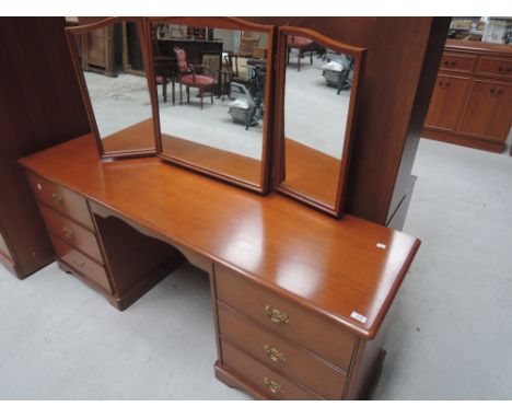 A stag style, light stained dressing table and bedroom drawers