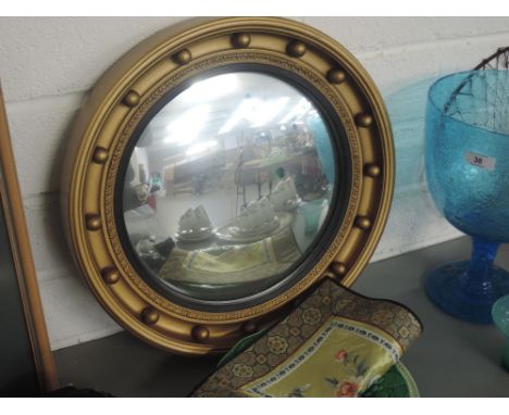 A circular gilt framed mirror, three decorative ceramic plates A/F and a silk panel
