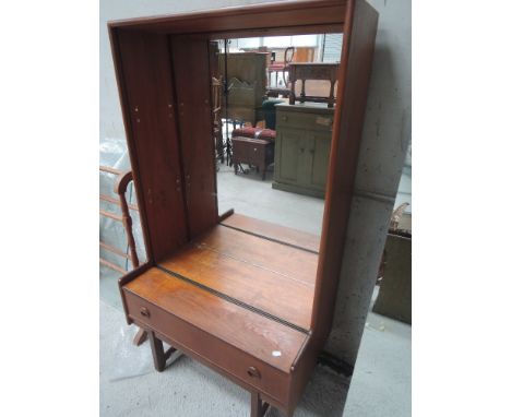 A vintage teak mirror back bookcase