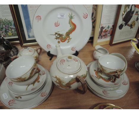 A Unity Oriental style tea service with dragon design and Geisha relief in cup base