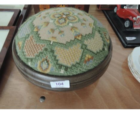 A circular tapestry foot stool