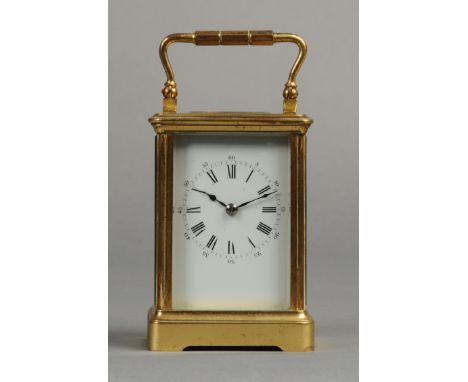 A SMALL LATE 19TH CENTURY FRENCH GILT BRASS TWO TRAIN CARRIAGE CLOCK, the white enamel dial with Roman and Arabic numerals, 1