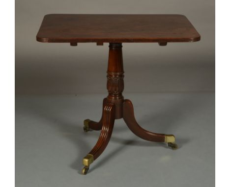 AN EARLY 19TH CENTURY MAHOGANY TILT TOP TABLE, rectangular, on a tripod base with carved stiff leaf collar to the pedestal an