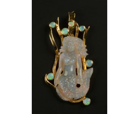 AN OPAL MERMAID PENDANT in 18ct gold, the carved and pierced opal figure is claw set against a wriven kelp surround collet se