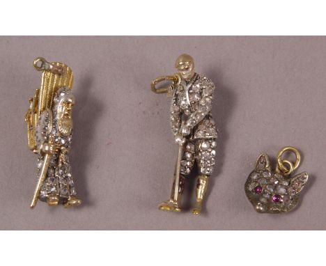 A DIAMOND SET CHARM FASHIONED AS A GOLFER, c1910, together with a diamond set fox mask, both in 9ct gold and silver and an Au