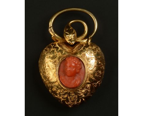 A VICTORIAN HEART SHAPED LOCKET set with a coral cameo in 18ct gold, the oval female portrait collet set to the centre of the