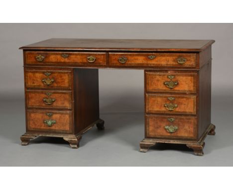 A WALNUT CROSSBANDED KNEEHOLE DESK in 18th century style,  inlaid with herringbone banding, having two drawers to the frieze 