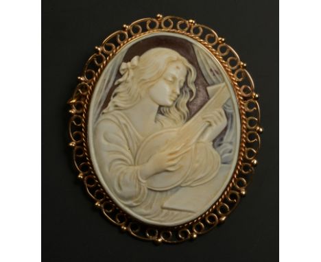 A SHELL CAMEO BROOCH in 9ct gold, of oval outline, female portrait playing a lute, collet set within a twisted wire, scroll a