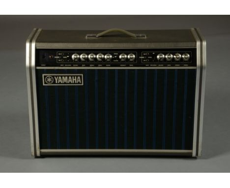 A YAMAHA YTA -95 AMPLIFIER, twin speakers and two channels, with Tremolo and Waw Waw function, grey tolex cover with brushed 