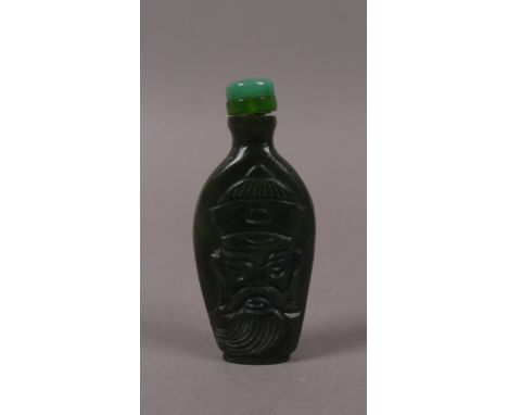 A SMALL CHINESE DARK GREEN JADE SNUFF BOTTLE AND STOPPER, carved with a bearded Chinaman, 6.5cm 