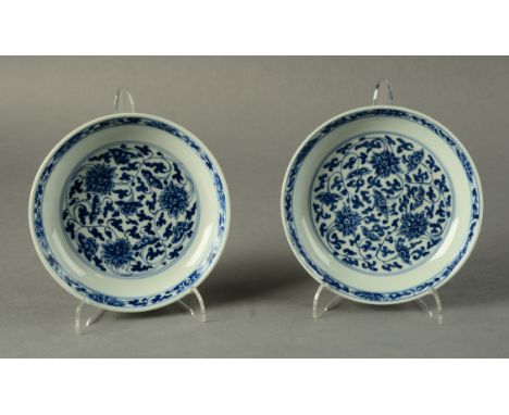 TWO CHINESE BLUE AND WHITE SAUCER DISHES, of almost identical design, decorated in underglaze blue with stylised scrolling ch