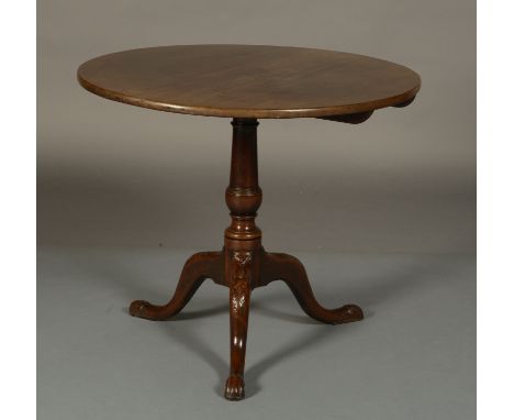 A GEORGE III MAHOGANY TILT TOP TABLE, circular, having a vase pedestal and on tripod base with acanthus carved cabriole legs,