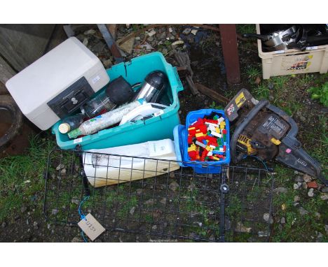 A quantity of miscellanea including a safe, Lego, kitchenware, bottles, and  a chainsaw.
