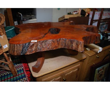 A coffee table made from a tree trunk.