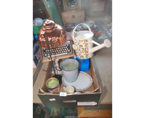 A box of miscellaneous including typewriter, candles, watering can, two copper light shades, etc.