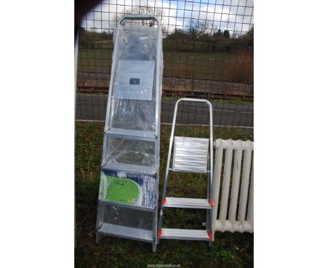 A three rung step ladder and a new five rung step ladder.