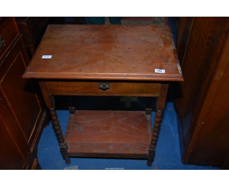 An Oak occasional table with barley twist legs, drawer and lower shelf, 24'' x 16'' x 31'' high.