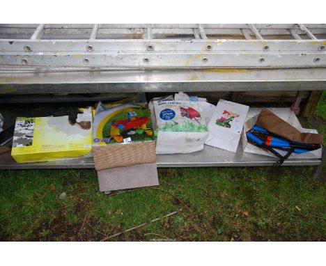 A garden gnome, a reel, child's play pool, garden tools, etc.