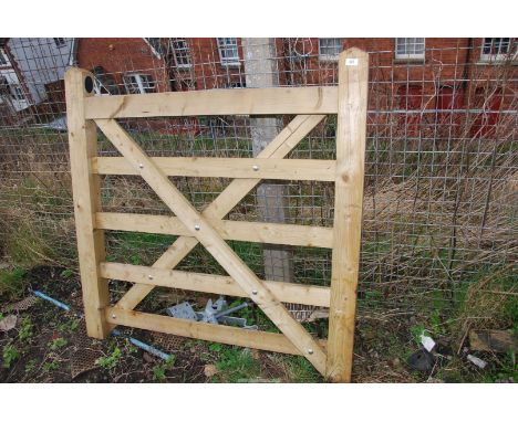 A small new wooden gate, 48'' x 48''.