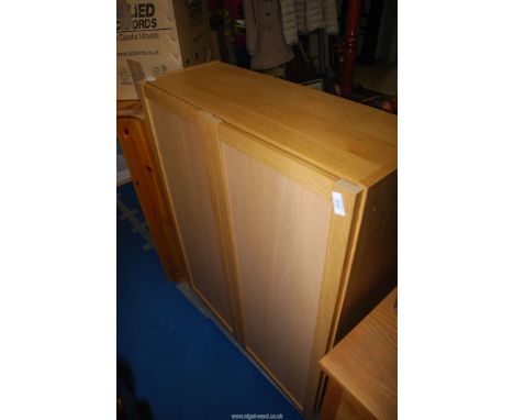 A light oak cupboard with three shelves, 31 1/2'' x 12'' x 42'' high.