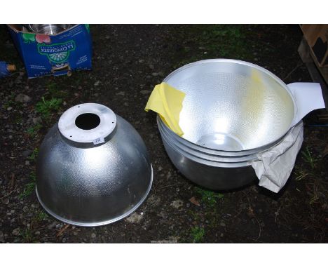 Five large aluminum industrial light shades.
