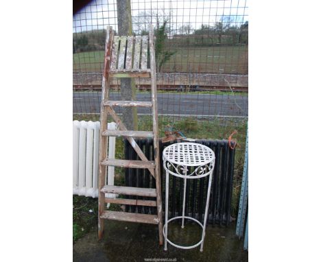 A six rung wooden step ladder and an aluminium plant stand.