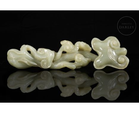 Jade of a light greenish hue. Carved in the shape of a ruyi sceptre, with an elongated, branch-shaped body, from which beauti