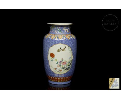 A ‘pink family’ porcelain vase with coloured enamel decorations. It has a balustraded profile, with a circular base, rounded 