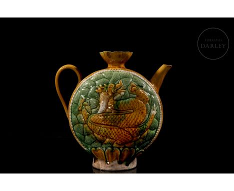 Modelled ceramic in the form of a jug, circular, with a flat rounded body in the shape of a full moon, flanked by a curved ha