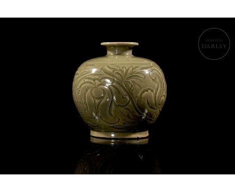 A small modelled ceramic vase with a rounded body and a short neck that ends in a turned-up mouth. The belly is decorated wit