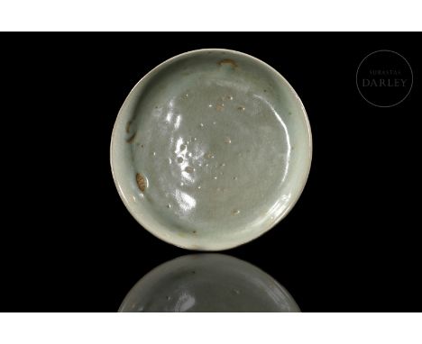 Modelled ceramic covered with a beautiful thick celadon glaze, greyish-blue in colour, with subtle craquelure. It has a flat 