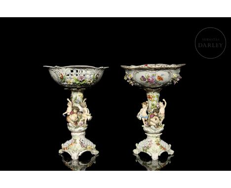 A pair of ceramic fruit bowls by Carl Thieme of Potschappel, Dresden. Decorated with small modelled infants and flowers and s
