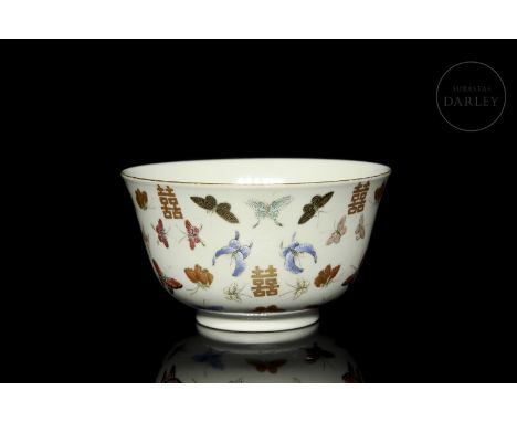 A porcelain bowl, with a narrow circular foot and a rounded body that widens slightly towards the mouth, which is covered wit