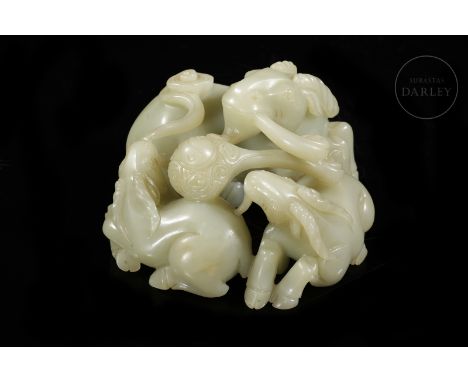 A light, milky-coloured jade. Carved in the form of three large-horned rams, one of which is larger, lying in the shape of a 