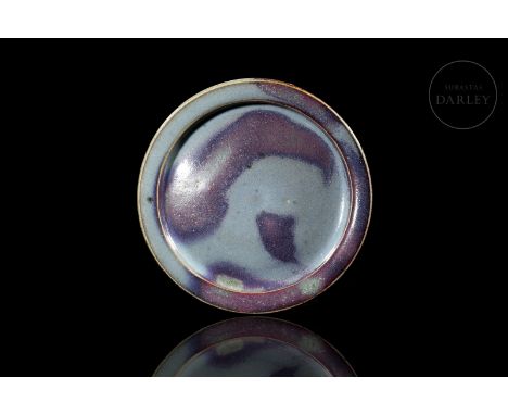 Made of ceramic covered with a thick, uniform blue glaze, with patches or splashes of intense purple of varying shades, light