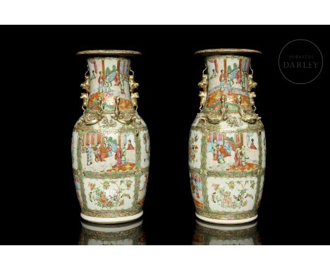 Two Cantonese porcelain vases with polychrome enamel decorations and gilt details. Decorated with palace scenes and small ani
