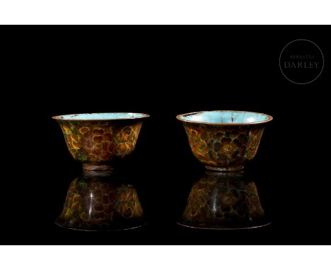 Beautiful bronze mugs with cloisonné enamel. They have a floral pattern covering the exterior, which contrasts with the inten