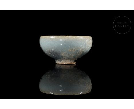 Ceramic decorated with a beautiful cream-blue glaze with delicate purple splashes. Modelled with a small circular foot and a 