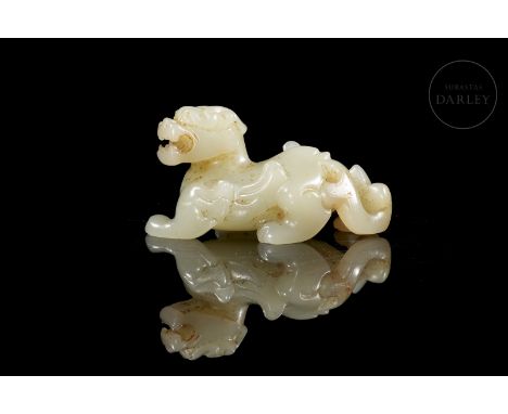 White jade with slight reddish flecks. Carved in the shape of a beast, it has a robust body, crouching on bent legs, with a l