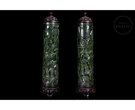 Jade of a deep spinach-green colour, carved in a cylindrical shape with a hollow interior. They are decorated with a continuo
