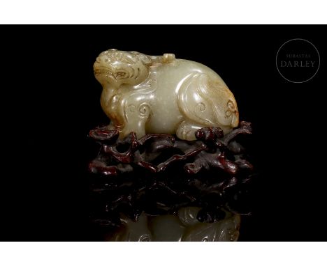 A light-toned jade figure with beautiful amber and reddish flecks. Masterfully carved in the form of a robust mythological be