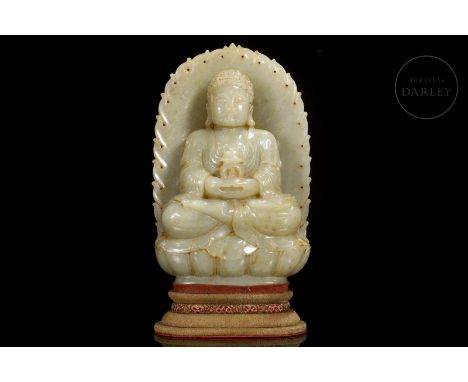 Light-toned carved jade with subtle amber flecks. It shows the deity seated on a throne in lotus position, with his hands in 