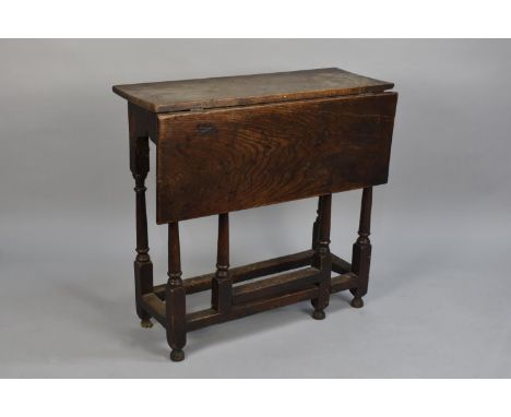 A Period Oak Narrow Side Gate Leg Single Drop Leaf Table, 77cms Wide and 28cms Deep 