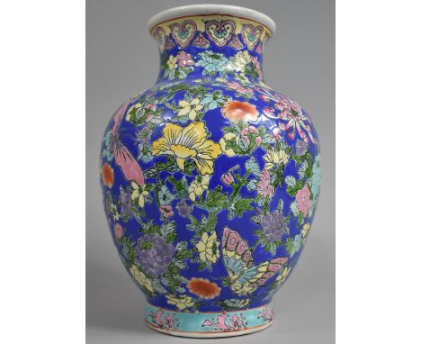 A Late 20th Century Chinese Porcelain Enamel Vase Decorated in Polychrome Enamels with Foliage and Flowers on Blue Ground, 30