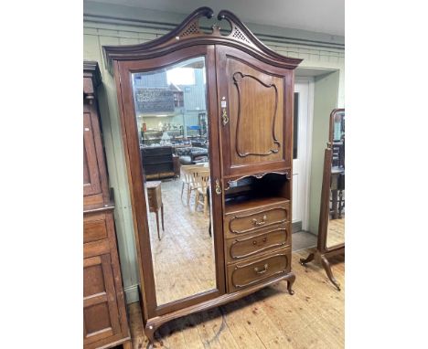 Late 19th/early 20th Century mahogany combination wardrobe having mirror door flanked by a cupboard door above an open compar