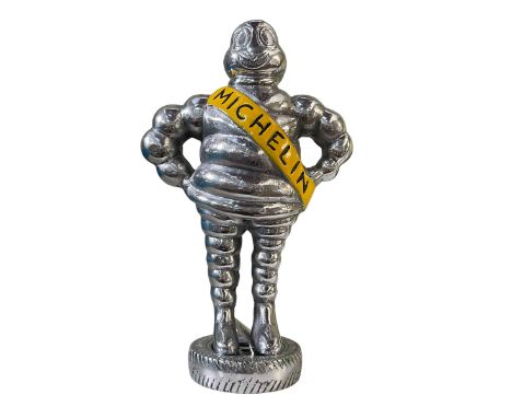 Small chromed model of the Michelin Man.
