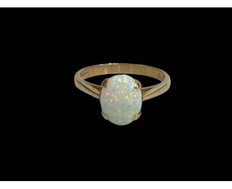 Oval opal claw set ring in 9 carat yellow gold, size O.