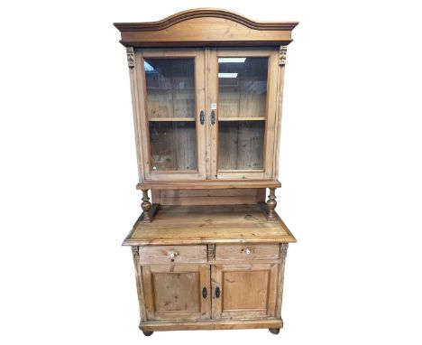 Continental pine dresser having two glazed panel doors above a base of two drawers and two cupboard doors, 216cm by 109cm by 